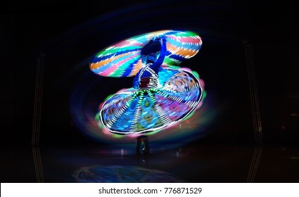 Happy Man Dancing Alone Wearing Lighting Dress Or Costume, And Spinning Very Fast On The Stage At Night In Desert Safari Dubai - With Blurred And Effects Background