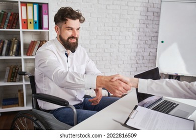 Happy Man With Disability Shaking Hands With HR. Cheerful Guy Just Got A Job. Employment And Inclusion Concept.