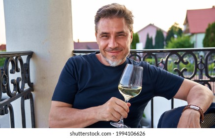 Happy Man Drinking Wine Outdoor Holding Wine Glass, Smiling. Wine Tasting In Vinery. Portrait Of Mature Age, Middle Age, Mid Adult Man In 50s.