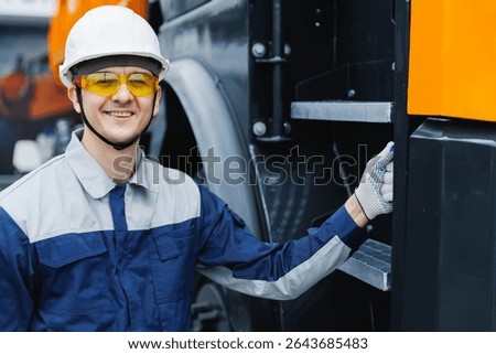 Happy Man driver builder operate crane or excavator at construction site. Industry worker portrait.