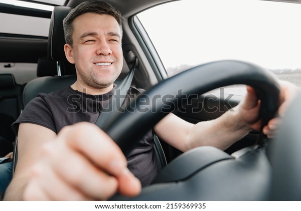 a happy\
man drives a car on the highway. car journey. driving school. an\
interesting and fascinating long road trip.\
