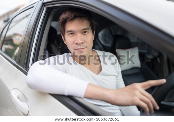 Happy man driving in car.Family safety\
transport road trip and happy people\
concept.