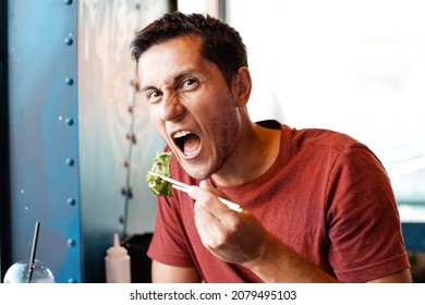 Happy Man Eating Asian Japanese Dumplings Jiaozi In Fastfood Restaurant Near The Window