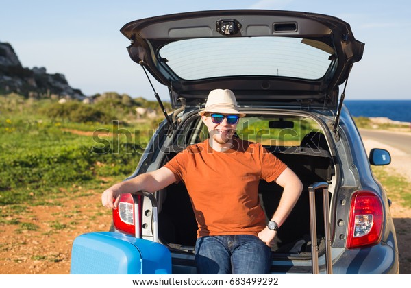 happy man enjoying road trip and summer
vacation. Travel, holidays and people
concept