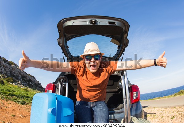 happy man enjoying road trip and summer\
vacation. Travel, holidays and people\
concept