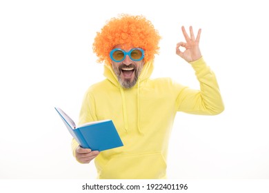 Happy Man In Funky Wig Show OK Sign Gesture Reading School Book In Geek Sunglasses, Education.