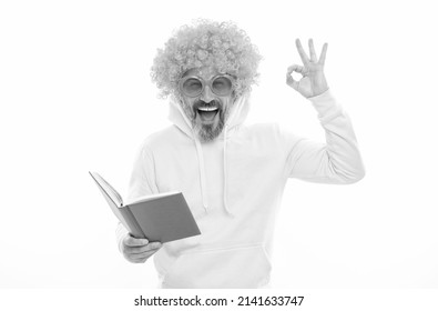 Happy Man In Funky Wig Show OK Sign Gesture Reading School Book In Geek Sunglasses, Education