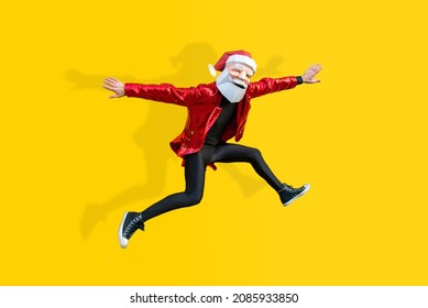Happy man with funny Santa Claus low poly mask on colored background - Creative conceptual idea for christmas advertising,adult with low-poly origami paper mask doing funny poses