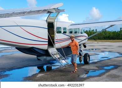 Happy Man Gets Into A Private Plane On The Islands.