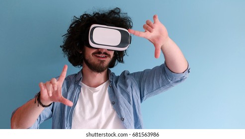 Happy Man Getting Experience Using VR Headset Glasses Of Virtual Reality, Isolated On Blue Background