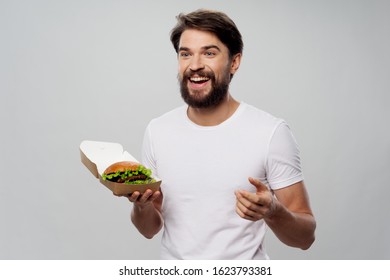 happy man with hamburger in paper boxes
