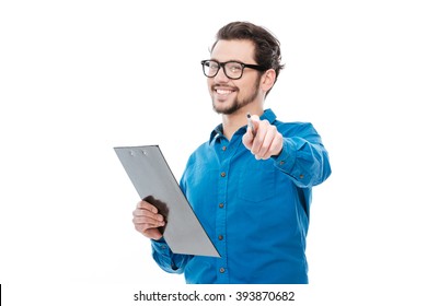 Happy man holding clipboard and pointing finger at camera isolated on a white background