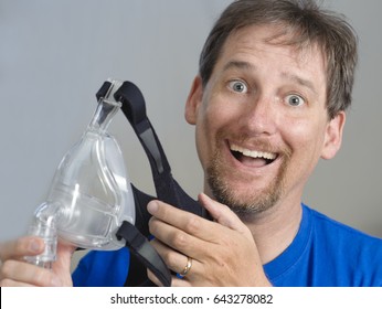 Happy Man Holding A Cpap Mask 