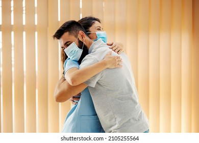 Happy Man Hugging His Female Doctor At Hospital. Medical Attention, Medical Service And Health Care.