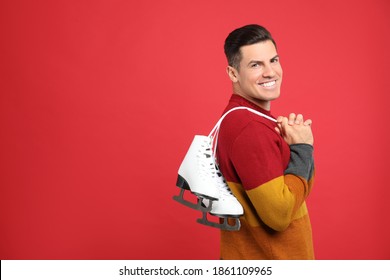 Happy Man With Ice Skates On Red Background. Space For Text