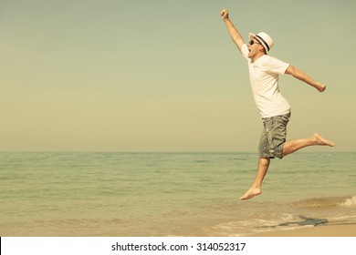 Happy Man Jumping On The Beach At The Day Time