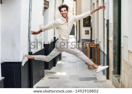 Similar – Young bearded man jumping in urban street