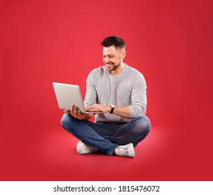 Happy Man With Laptop On Red Background