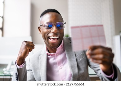 Happy Man Looking At Winning Lottery Ticket - Powered by Shutterstock