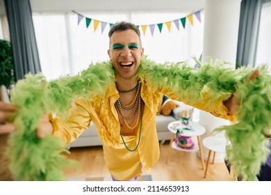 Happy Man In Mardi Gras Costume Having On While Celebrating Festival At Home Party Ad Looking At Camera. 