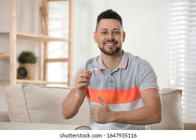 Happy Man With Nicotine Patch And Cigarette At Home