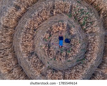 Happy Man On Crop Circle In Oat Field, Aerial View