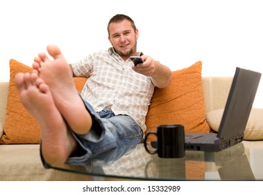 happy man on sofa with laptop