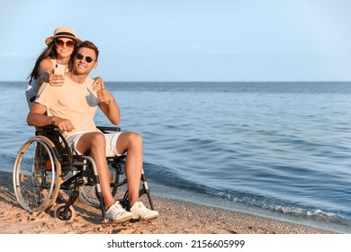 Happy Man With Physical Disability And His Girlfriend Taking Selfie At Sea Resort