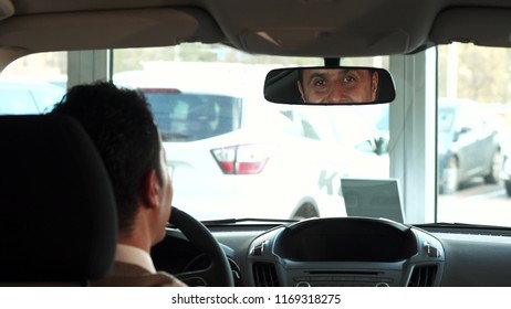 A Happy Man Is Preparing To Make His First Trip On A New Car