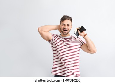 Happy Man With Purse On Light Background