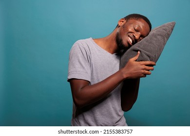 Happy Man Putting Head On Comfortable Pillow To Sleep And Take Nap In Studio. Exhausted Guy Trying To Get Rest After Passing Bedtime And Dealing With Insomnia, Sleeping Schedule.