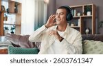 Happy man, relax and listening with headphones on sofa for music, podcast or radio sound at home. Male person, listener or smile with tune for audio vibe, song playlist or rhythm on couch at house
