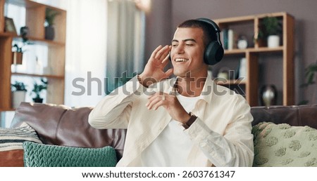 Happy man, relax and listening with headphones on sofa for music, podcast or radio sound at home. Male person, listener or smile with tune for audio vibe, song playlist or rhythm on couch at house