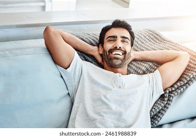 Happy man, relax and lying on couch for leisure, resting and weekend break in living room. Happiness, cozy and male person with arms out on sofa for lazy Saturday, comfortable or day off in home - Powered by Shutterstock