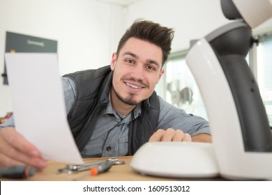 Happy Man Repairing Broken Coffee Machine