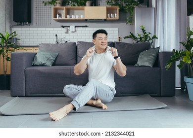 Happy Man Is Resting After Morning Exercise, Asian Is Doing Fitness At Home On A Sports Mat