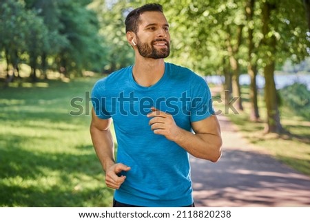 Similar – Image, Stock Photo Young athletic caucasian listening to music at sunset
