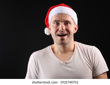 Happy Man In Santa Hat On Black Background.