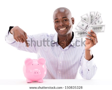 Happy man saving money in a piggybank - isolated over white 