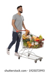 Happy Man With Shopping Cart Full Of Groceries On White Background