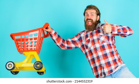 Happy Man With Shopping Cart Show Thumb Up. Buying Spree. Supermarket. Sale. Discount. Black Friday.