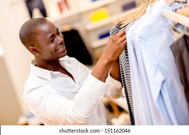 Happy Man Shopping For Clothes At A Store 