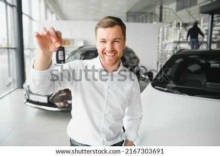 Happy man showing the key of his new car Stock photo © 