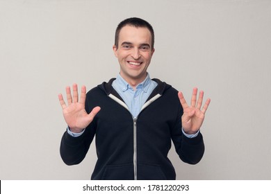 Happy man shows fingers nine, white background