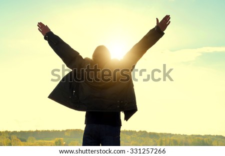 Happy Man Silhouette with Hands Up on the Nature Background
