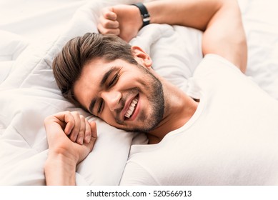 Happy Man Sleeping In Bedroom