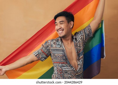 Happy Man Smiling And Standing With Pride Flag. Gender Equality And LGBTQ Concept.