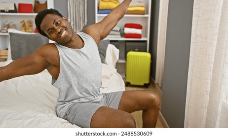 Happy man stretching in a modern bedroom, with neutral decor and a bright suitcase. - Powered by Shutterstock