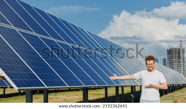 Happy man student of industry university\
background solar panel power\
station.