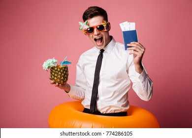 Happy man in sunglasses and official shirt showing cocktail and international passport isolated